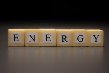 The word ENERGY written on wooden cubes isolated on a black background...