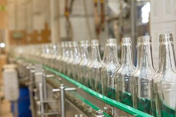 Bottles are moving on a conveyor belt at a factory for the production of Russian vodka