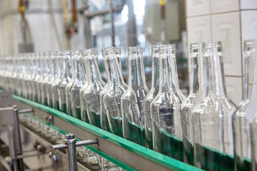 Bottles are moving on a conveyor belt at a factory for the production of Russian vodka