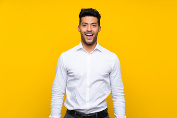Fototapeta na wymiar Young handsome man over isolated yellow background with surprise facial expression