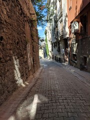 Alley in Istanbul, Turkey with cobblestone street, stone walls