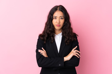 Obraz premium Mixed race business woman over isolated pink background keeping arms crossed