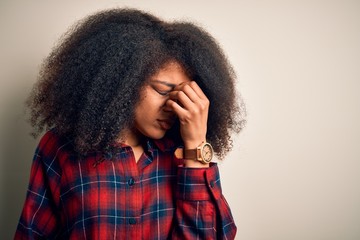 Young beautiful african american woman wearing casual shirt over isolated background tired rubbing nose and eyes feeling fatigue and headache. Stress and frustration concept.