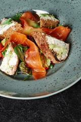 salmon salad with toast in a blue plate