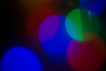 Colorful circular Christmas lights. Christmas tree bokeh.Bokeh effect. Green, blue, red and yellow lights christmas background.