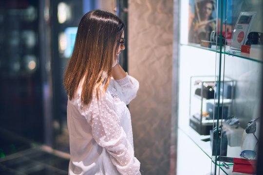 Young beautiful woman on vacation smiling happy and confident. Standing on a deck of ship with smile on face doing a cruise