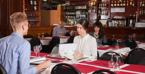 Woman with male friend in restaurant