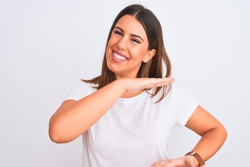 Fototapeta premium Portrait of beautiful and young brunette woman standing over isolated white background gesturing with hands showing big and large size sign, measure symbol. Smiling looking at the camera. Measuring