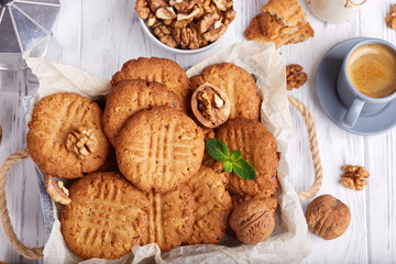 Delicious homemade crispy cookies with walnuts. Served with cup of coffee. 