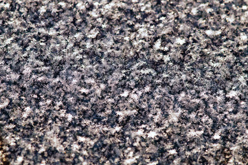Surface covered with snowflakes, close-up. Macro. Texture background, horizontal position. Snow flakes with an openwork pattern created by nature.