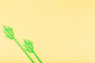 Madler in the form of a cactus for mixing drinks on a yellow background