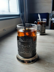 glass of whiskey and ice on wooden table