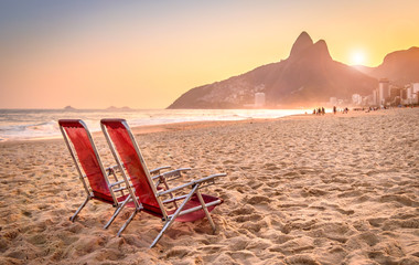 Beach deck chair against a backdrop of Two Brothers Mountain in Rio de Janeiro, Brazil