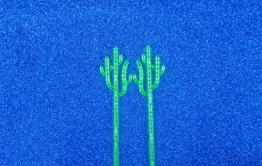 Madler in the form of a cactus for mixing drinks on a blue background