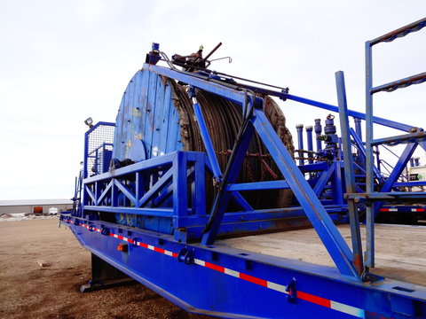 Oilfield coiled tubing equipment. Coiled tubing reel on a trailer. Oil patch machinery 