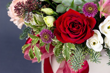 floral fresh arrangement of bright flowers in a hat box gray background copy space