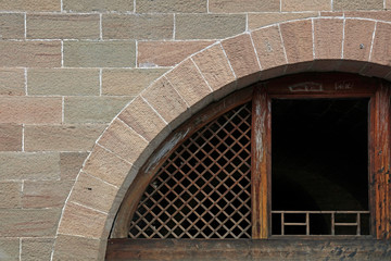 Stone walls and wooden window lattices