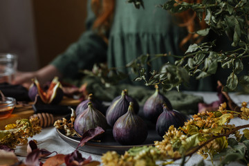 On the table in a plate is fresh figs