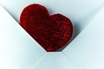 Envelope with red heart inside for valentine day or other holiday to show love