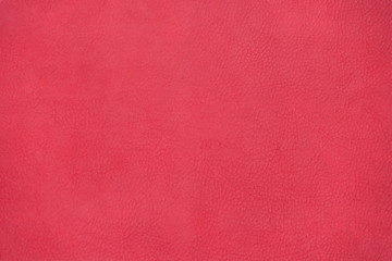 Red leather texture background surface. Close-up.