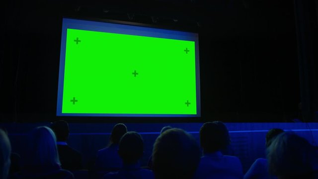 In the Movie Theater Captivated Audience Watching New Blockbuster Film on Mock-up Green Screen. People Watching Video Game Tournament Streaming, Live Concert Video, New Product Release Trailer