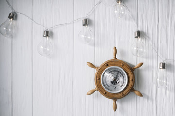 Sea barometer on a white wooden background
