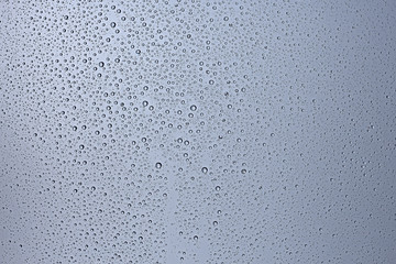 gray wet background / raindrops to overlay on the window, weather, background drops of water rain on the glass transparent