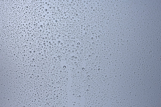 gray wet background / raindrops to overlay on the window, weather, background drops of water rain on the glass transparent