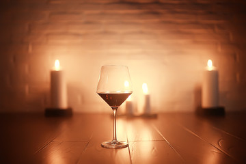 red wine glass serving / romantic dinner in the interior of the restaurant, a table served with a glass of grapes wine