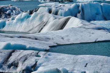 Fototapeta na wymiar Glacier and calved ice and icebergs at the Jokulsarlon Lagoon in Iceland