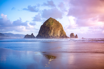 Haystack at Cannon Beach, Oregon on beach during sunset with Ocean view
