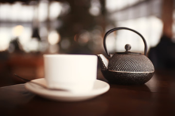 English tea in a cafe / cup and kettle with five o'clock tea