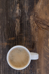 Coffee cup top view on dark wood table with copy space