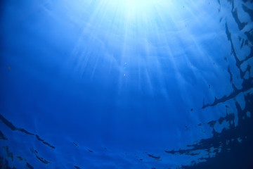 ocean water blue background underwater rays sun / abstract blue background nature water