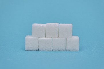 Neatly folded sugar cubes on a blue background
