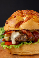 Bacon Cheese Burger with tomato, lettuce and a drop of mayonnaise.