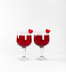 Cherry-strawberry drink, cocktail with jelly marmalade hearts on a white background