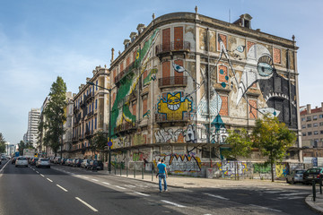 Graffiti on the walls of an old house in the center of Lisbon on a sunny autumn day. Lisbon, Portugal.