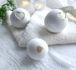 Beautiful spa cosmetic composition. Close up bath bombs, towel on white background. Love or health lifestyle concept