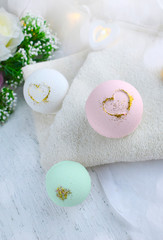 Fototapeta na wymiar Romantic spa composition. Pastel bath bombs with flowers on towel. Valentines day, Mothers day, wedding lifestyle concept