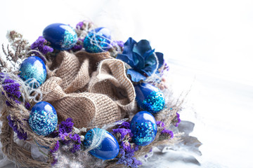 Easter wreath with blue eggs with sequins.