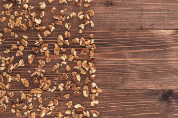 Raw walnut kernels on an old rustic wooden table