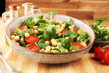 chickpea salad with ingredient and tomatoes and lamb´s lettuce. healthy salad