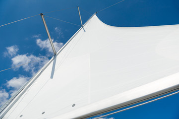 Mast and sail of brand new sailing yacht. Medeiterranean sea, Italy.