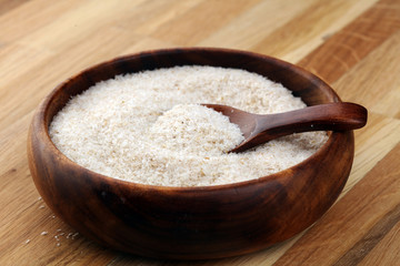 Portion of Psyllium Seeds on rustic dark background. Psyllium seed husks on wood