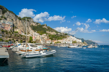 Fototapeta na wymiar Amalfi harbor with lots of boats. Popular travel destination of Italy.
