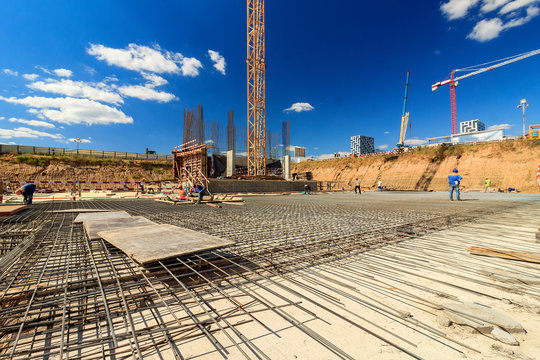 Bar bender fixing steel reinforcement for house concrete floor slab. construction worker Concrete pouring during commercial concreting floors of building in site and Civil Engineer. 