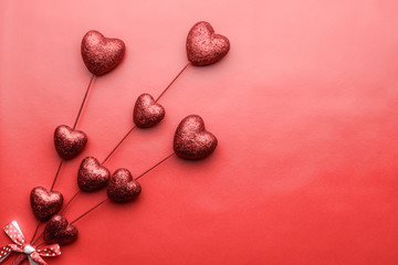 Valentine day composition. Red tiny hearts on sticks on red background. Romantic Scattered Hearts Texture. Love.