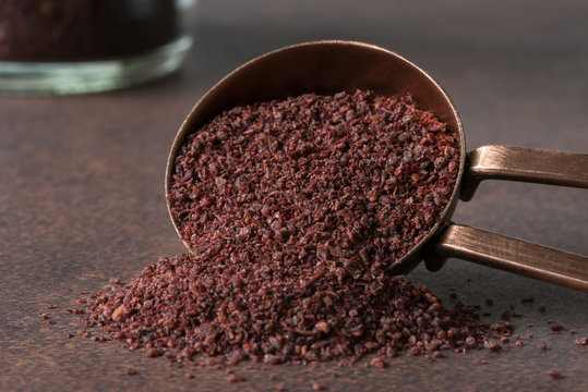 Ground Sumac Spilled from a Teaspoon