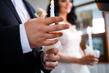 bride and groom lighting a candle together on a wedding day